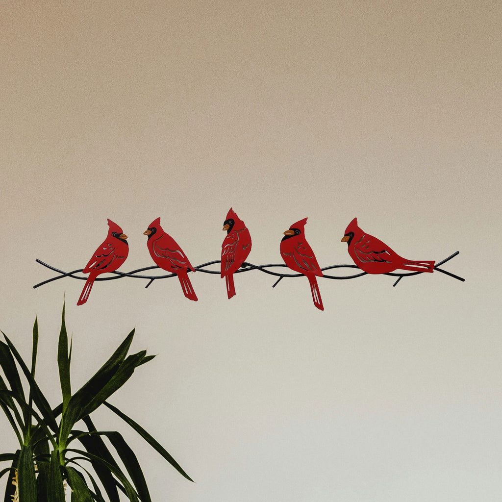 Cardinals on a branch metal wall art.