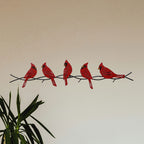 Cardinals on a branch metal wall art.