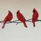 Cardinals on a branch metal wall art.